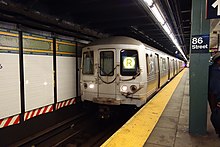 A view of the new wall tiling as an out-of-service R train passes through the station. 86th St 4th Av BMT td (2018-09-19) 19.jpg