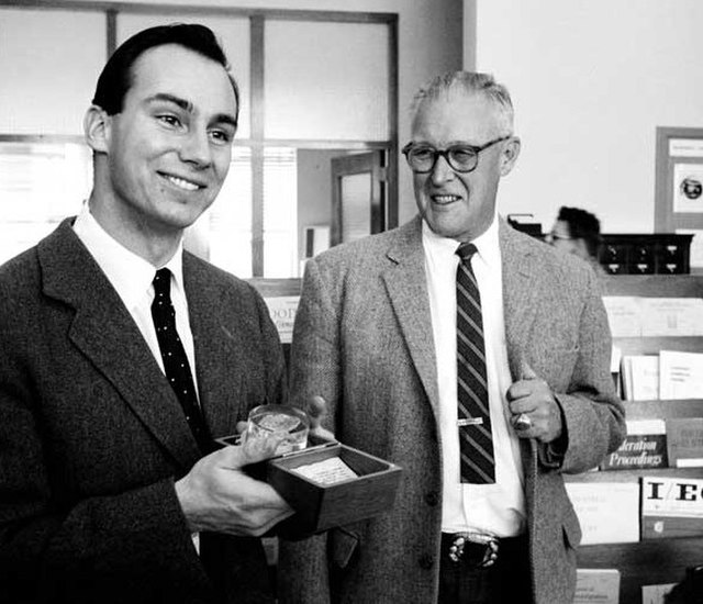 Aga Khan IV receiving a gift of Trinitite, residue from the first nuclear bomb detonation, while visiting the Los Alamos National Laboratory in 1959.