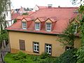 Residential house in half-open development, with side wing