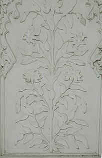 Floral designs on marble, as seen on the tomb's interior walls