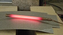 Running current through a material with resistance creates heat, in a phenomenon called Joule heating. In this picture, a cartridge heater, warmed by Joule heating, is glowing red hot. Cartridge-heater-hot.jpg