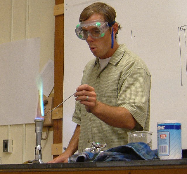 The presence of copper in this qualitative analysis is indicated by the bluish-green color of the flame