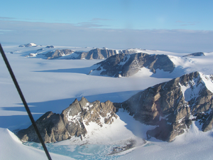 Aerial view to the east of north escarpment, Fosdick Mountains. Mount Bitgood is in the near field, Mount Colombo middle distance, and Mount Perkins is the peak at the horizon.