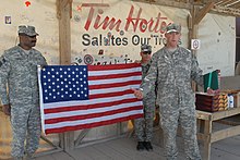 A United States Army sergeant making a speech in front a Tim Hortons coffee shop in Kandahar GIs celebrate reenlistment at Kandahar's Tim Hortons.jpg
