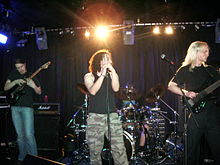 Haken performing live in 2009. From left to right: Henshall, Jennings, Hearne, and Thomas MacLean.