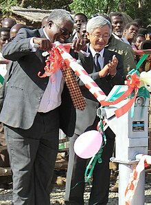 Mpinganjira opens a water borehole with the Japanese ambassador (2013) Hon Brown Mpinganjira inaugurates borehole (cropped).jpg