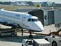 A JetBlue airplane parked at the gate.