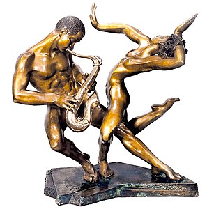 Sculpture of two nudes, one dancing and the other playing a saxophone