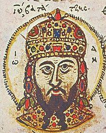 Head of a bearded man wearing a crown.
