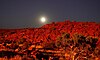 Moonrise over Murujuga, floodlit by gas flare