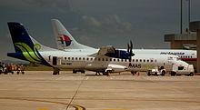 A MASwings ATR 72 parked next to a Malaysia Airlines Boeing 737.