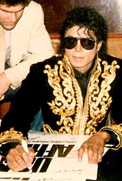 Michael Jackson autographing 'We Are The World' posters 1985.jpg