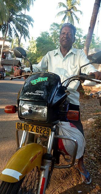 Yellow-and-black motorcycle pilot in Saligao, Goa. Motorcycle-pilot-goa-india.jpg