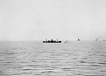 Deucalion after being damaged by a bomb. A destroyer, presumably HMS Bramham, is standing by. Operation Pedestal, August 1942 A11188.jpg