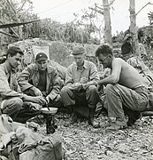 Photograph of Edward P. Kraspe (Phm2-c), Lt. Arlington Bensel Jr., Ernie Pyle, and Cpl. Edward M. Wrenne - DPLA - 7ad1461ceae262818e71f8be40aac55a.jpg