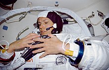 Sullivan dons her space suit in case an EVA was required to support the Hubble Space Telescope deployment on STS-31. STS-31 Mission Specialist (MS) Sullivan dons EMU in Discovery's airlock.jpg