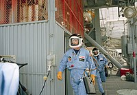 Astronauts Richard O. Covey (front) and Joe H. Engle rush from the Discovery during emergency launch-mode egress training at Kennedy Space Center. STS 51-I emergency training.jpg
