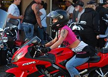 Riders have a range of different options in choosing equipment that balances safety with other priorities. She and her Honda at Bike Week 2009 Daytona.jpg