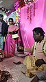 Sindur daan Hindu ritual as the groom is full blind ladies assisting her to complete rituals at Voice Of World Kolkata 04