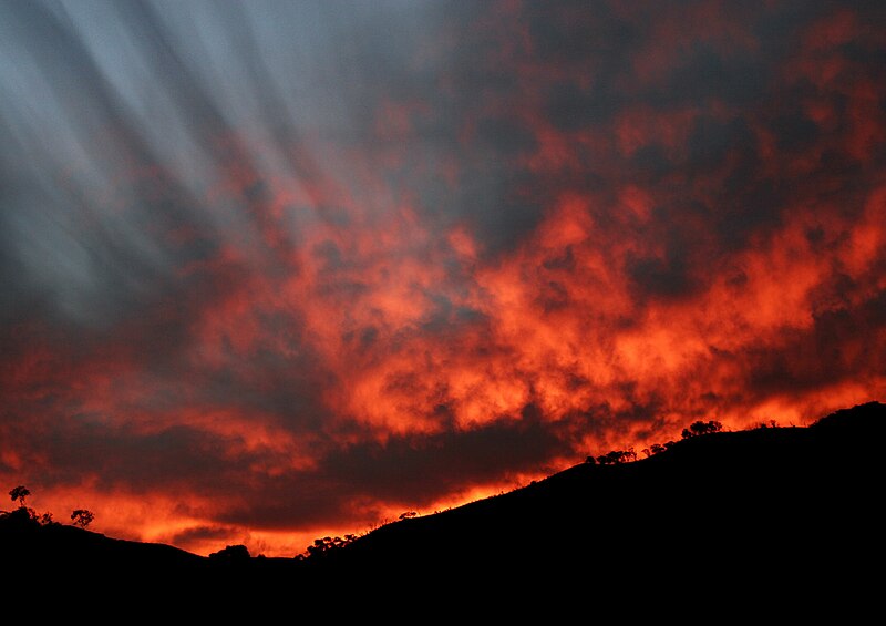 File:Sunset with funnel clouds.jpg