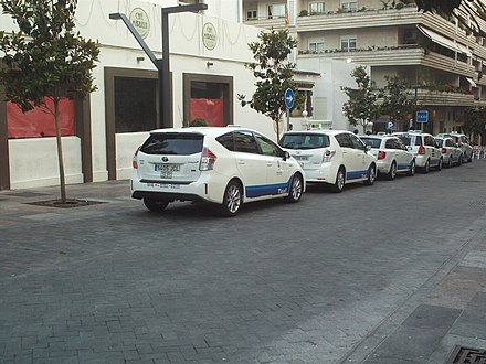 Marbella's own taxis are white with a blue strip