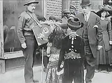 The theater manager rescues the children from the organ grinder