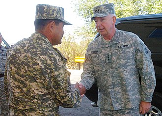 Major General Adilbek Aldaberpenov (left) of the Kazakh Airmobile Forces greets General Webster at KAZBAT headquarters, 1 October 2009. US Army 52136 Steppe Eagle exercise increases interoperability.jpg