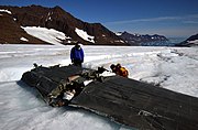 US Navy 040809-N-0331L-006 Lt. Cmdr. Christopher Blow, left, and Lt. Cmdr. Steve Dial examine the wreckage of a Navy P-2V Neptune aircraft that crashed over Greenland in 1962.jpg