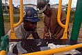 US Navy 081117-N-3595W-092 Air Force Airman 1st Class Pasha Hughes and Engineering Aide 2nd Class Hugo Lerma work together building a new playground for a local community.jpg