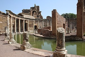 Roman ruins with columns around a pool