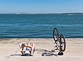 Image 45Woman reading a book next to an upside down bicycle, Cais do Sodré, Lisbon, Portugal