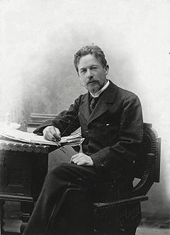 Chekhov seated at a desk