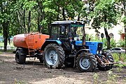 A MTZ-82.1 / Belarus-82.1 (Russian: МТЗ-82.1 / Беларус-82.1) tractor with street sprinkling equipment and a towed water tank. A three-quarter view. 2014.