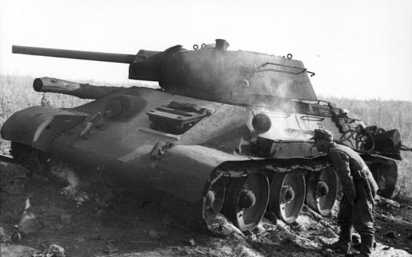 A German soldier inspects a T-34 tank knocked out at Pokrovka that is still smoldering. Pokrovka is 40 kilometres (25 mi) southwest of Prokhorovka.