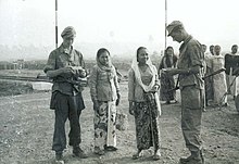 Dutch soldiers control the papers of Javanese women, 1946 COLLECTIE TROPENMUSEUM Nederlandse militairen controleren de papieren van Javaanse vrouwen bij het transitkamp van de Zeven December Divisie bij Tandjong Priok of het hierna door de divisie betrokken Kamp Doeri Batavia TMnr 10029000.jpg
