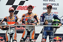 Dani Pedrosa, Marc Marquez and Jorge Lorenzo, celebrating on the podium after finishing second, first and third at the MotoGP race. Dani Pedrosa, Marc Marquez and Jorge Lorenzo 2013 Indianapolis 2.jpg