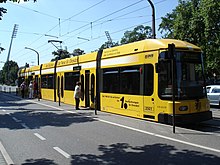 A DW 6-axle car at a tram stop; note the level boarding between stop and car DresdenTram1.jpg