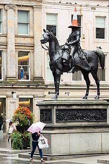 The statue has become known for having traffic cones placed upon its head Duke of Wellington coned statue Glasgow.jpg