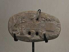 Tablette de comptabilité avec empreinte de sceau représentant une scène de tissage. Suse, niveau II, Uruk récent. Musée du Louvre.