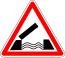 A triangle with white background and red border, with a symbol of an open draw bridge
