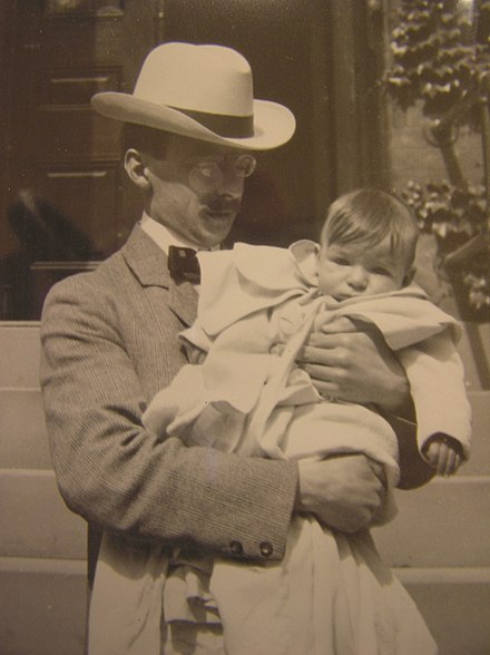 Young Melville Grosvenor is held by his father, Gilbert H. Grosvenor, first Editor of the National Geographic Magazine, 1902.