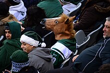 "A person wearing a Horse Head Mask looks downright disturbing," according to the original manufacturer Archie McPhee. Man with Horse Head Mask in the Stands.jpg