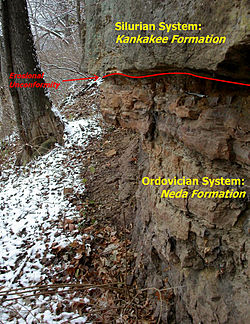 At Kankakee River State Park. The black pencil near the right center of the picture is near the Silurian-Ordovician contact. Maquoketa Group (with annotations).jpg