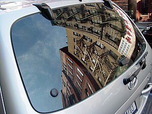 New York City architecture reflected in a car ...