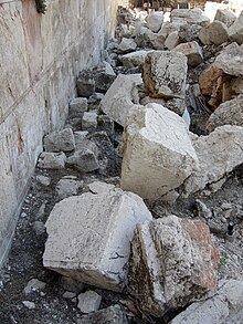 Excavated stones from the Western Wall of the Temple Mount (Jerusalem, Israel), knocked onto the street below by Roman battering rams in 70 CE NinthAvStonesWesternWall.JPG