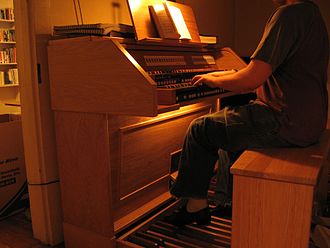 Organist wearing organ shoes (January 2007) Organist-with-close-up-of-organ-shoes-and-pedalboard.JPG