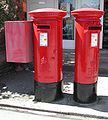 Father and daughter pair: George VI and Elizabeth II pillar boxes at Bembridge Post Office Isle of Wight. One was for local mail and the other for off-island post.