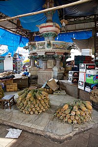 Fruit stalls around the fountain. Pineapple Stall and Fountain (14671387381).jpg