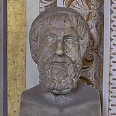 Buste van een wat oudere en nogal vermoeide man met een korte, gekrulde baard, vaag vergelijkbaar met Griekse bustes van Homerus