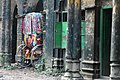 The colourful back of a cycle-rickshaw amongst old, black columns in Sonargaon, by Nafis Kamal